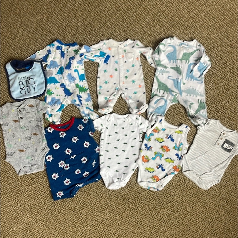 Bundle of 9. 3 sleepers - 2) are newborn size (1) is 0/3 months. 5 onesies 1 bib